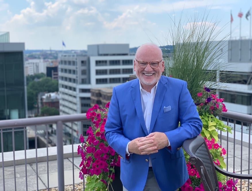 A photo of Richard A Clarke standing on a balcony in Washington DC